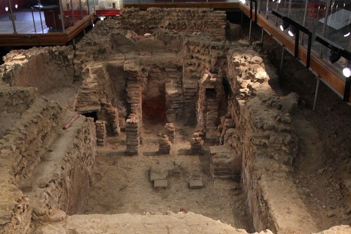 Walls and brick pillars of the Roman bath house in its vault