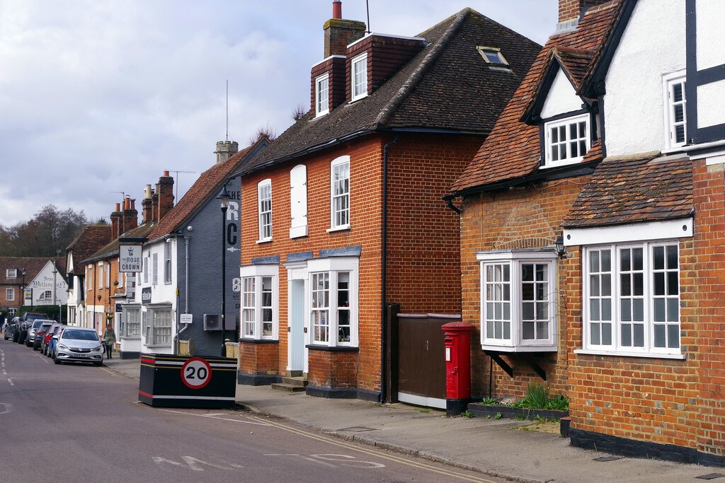 Brick cottages and a red post box on Church Street in Welwyn